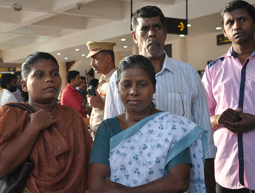 Family members of Indian nurses who had been stranded in territory held by Islamic militants in Iraq await their arrival at the airport in Kochi.