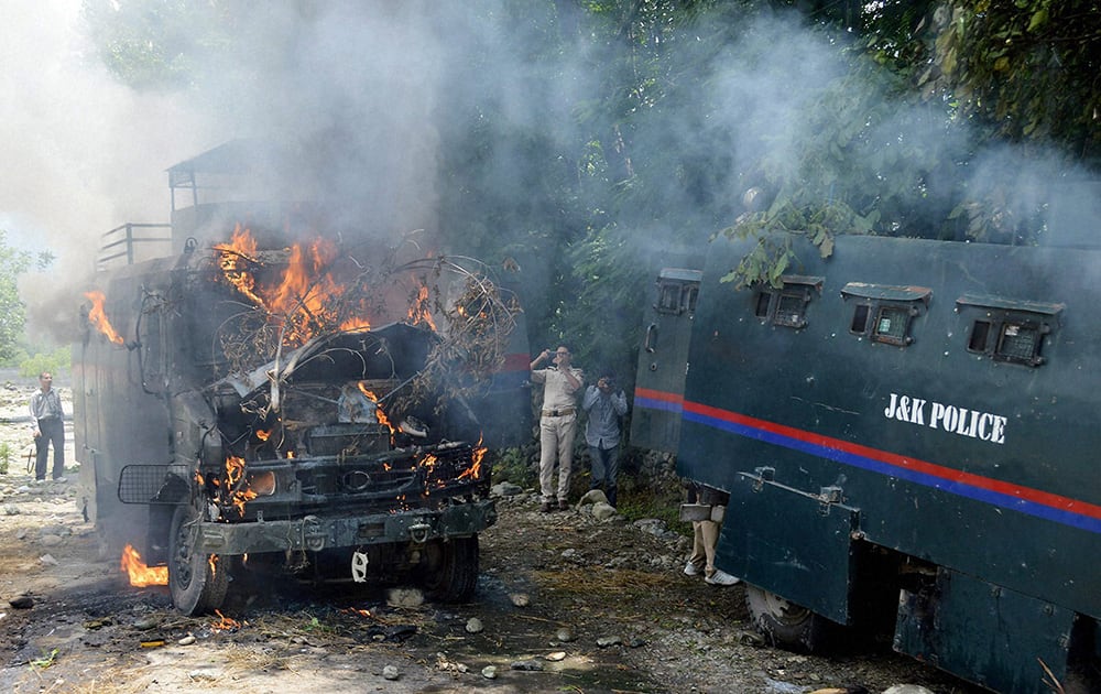 Protesters torch two police vehicles in Tral town.