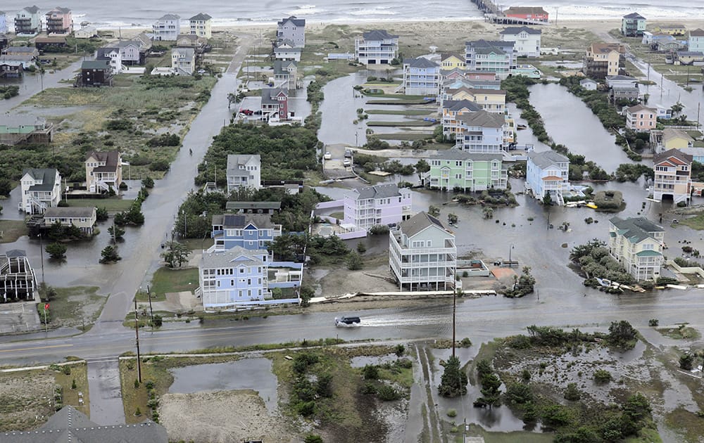 This photo provided by the US Coast Guard shows flooding caused by Hurricane Arthur on the Outer Banks of North Carolina.