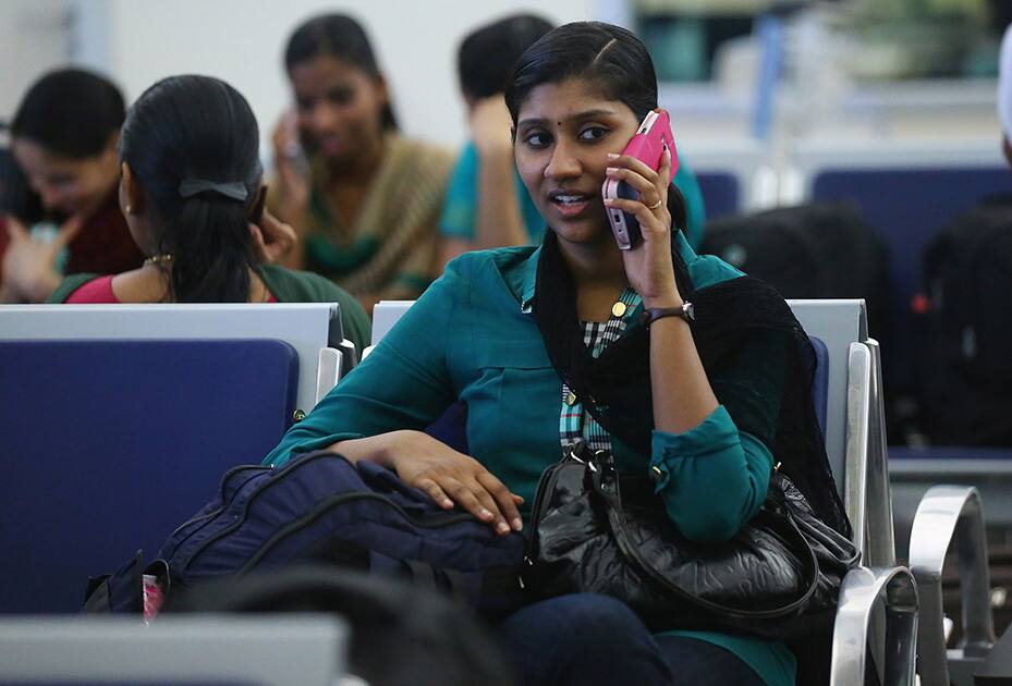 Indian nurses who were trapped in territory captured by Islamic militants wait for the plane to begin their journey home at Irbil International Airport, Iraq.