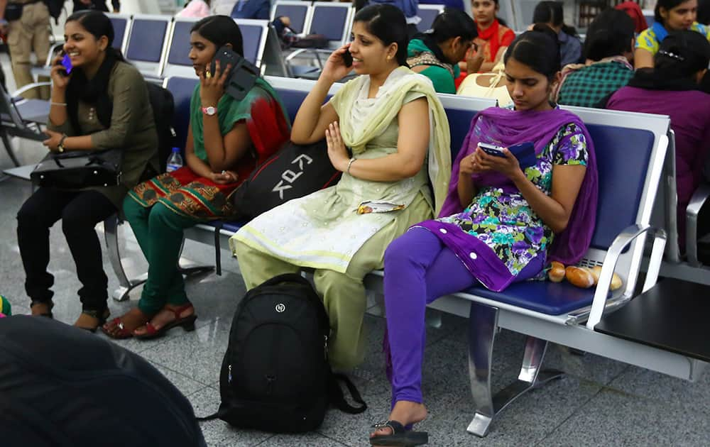 Indian nurses who were trapped in territory captured by Islamic militants wait for the plane to begin their journey home at Irbil International Airport, Iraq.