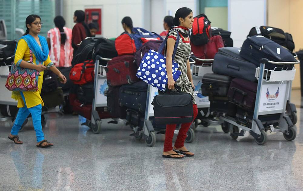 Indian nurses who were trapped in territory captured by Islamic militants wait for the plane to begin their journey home at Irbil International Airport, Iraq.