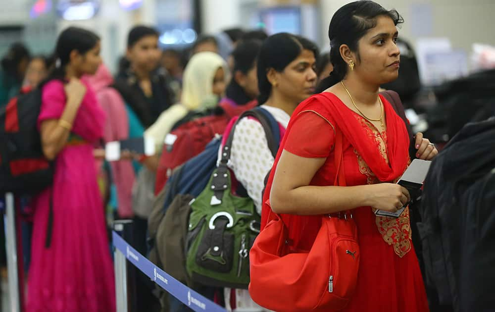 Indian nurses who were trapped in territory captured by Islamic militants wait for the plane to begin their journey home at Irbil International Airport, Iraq.