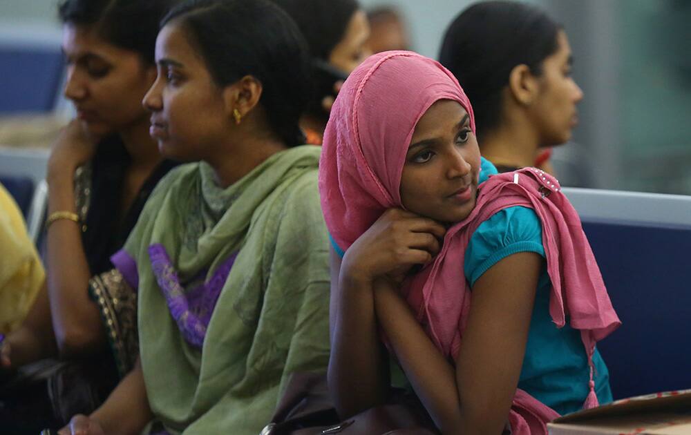 Indian nurses who were trapped in territory captured by Islamic militants wait for the plane to begin their journey home at Irbil International Airport, Iraq.