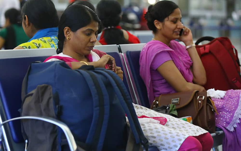 Indian nurses who were trapped in territory captured by Islamic militants wait for the plane to begin their journey home at Irbil International Airport, Iraq.