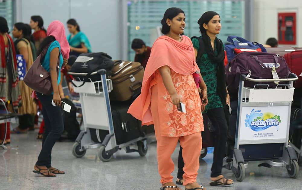 Indian nurses who were trapped in territory captured by Islamic militants wait for the plane to begin their journey home at Irbil International Airport, Iraq.