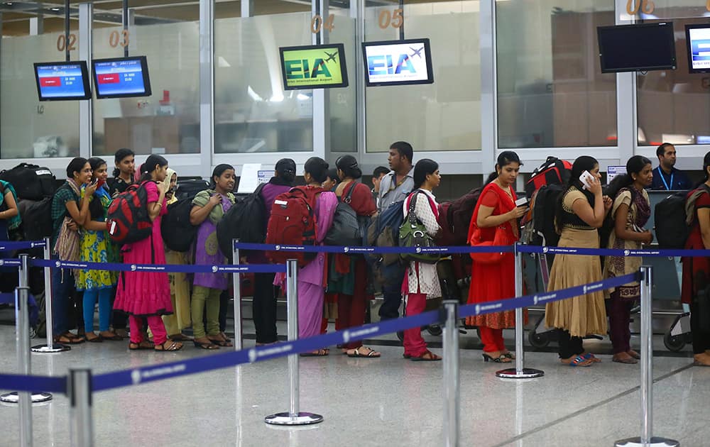 Indian nurses who were trapped in territory captured by Islamic militants wait for the plane to begin their journey home at Irbil International Airport, Iraq.