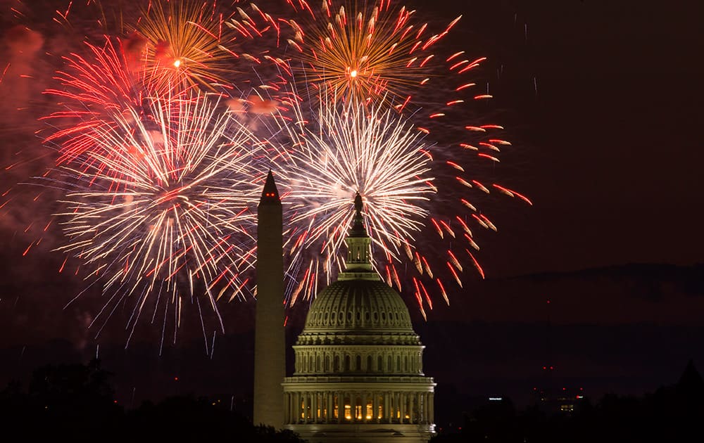 Fireworks illuminate the sky over the US Capitol building and the Washington Monument during Fourth of July celebrations, in Washington. 