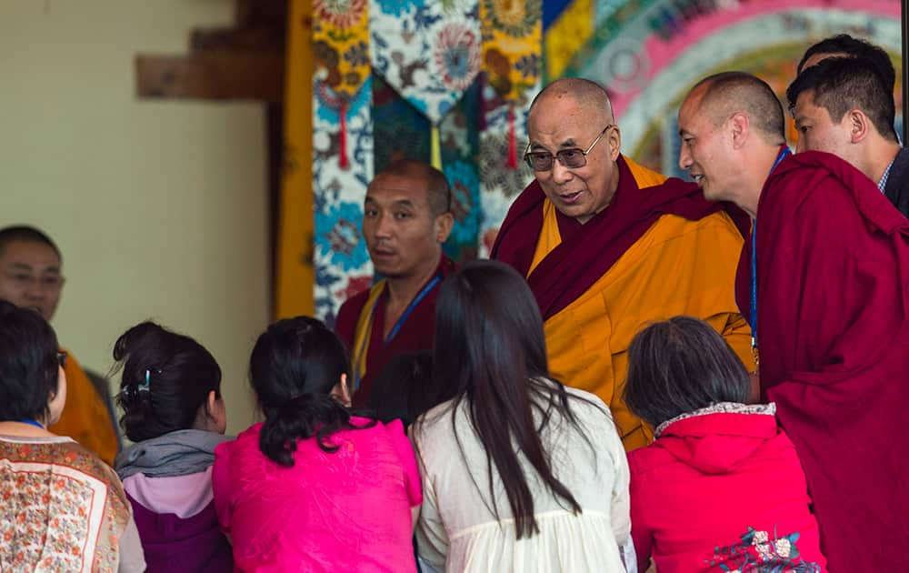 Tibetan spiritual leader the Dalai Lama meets foreign devotees he leaves the prayer ground for lunch during the second day of Kalachakra initiations near Leh.