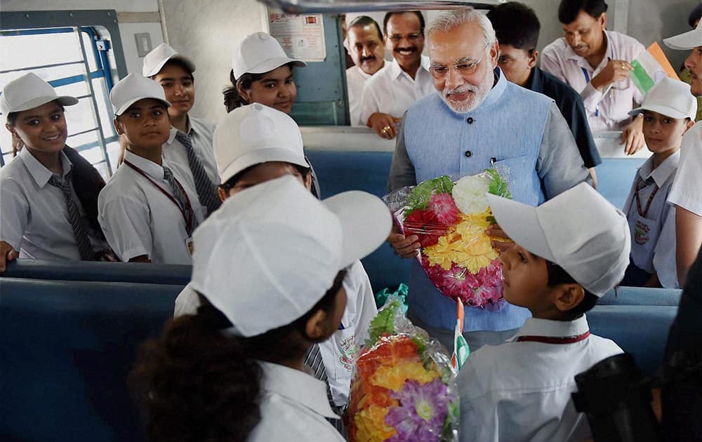 Prime Minister Narendra Modi interacts with children on board the inaugural train on the Katra-Udhampur rail link.