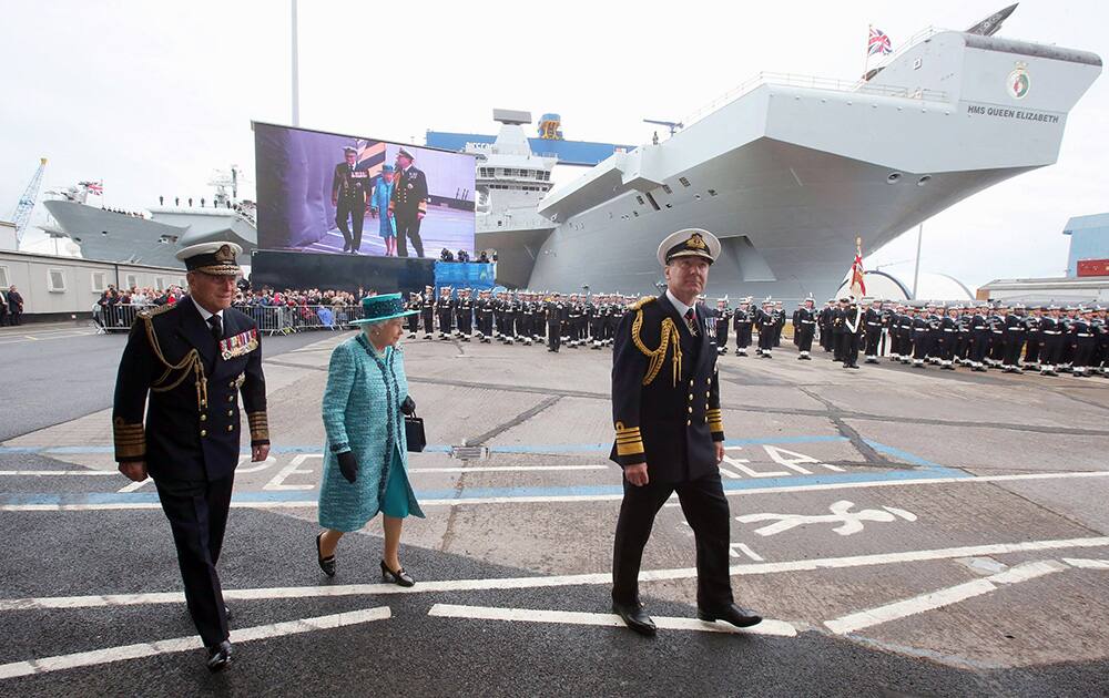 Britain`s Queen Elizabeth II and the Duke of Edinbugh arrive for the naming ceremony of the HMS Queen Elizabeth, in Rosyth Dockyard, where the Queen will formally name the Royal Navy`s biggest ever ship, with whisky replacing the more traditional champagne at the ceremony, in Fife, Scotland.