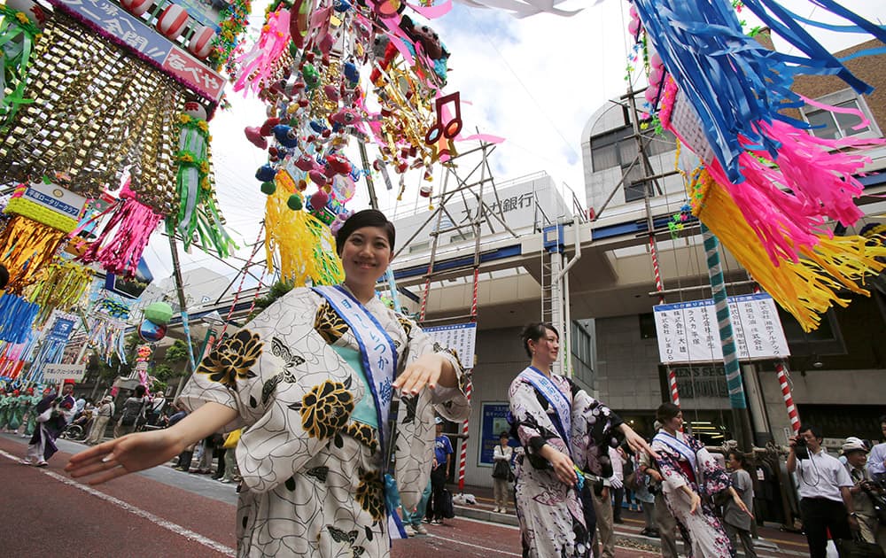 People dance under colorful decorations for the Tanabata Star Festival in Hiratsuka, near Tokyo.