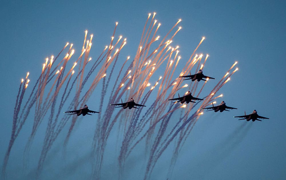 Belarusian army jet fighters fly and launch flares during a parade marking Independence Day in Minsk, Belarus.