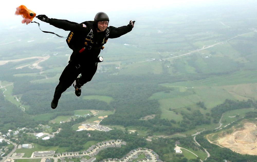 A member of the United States Army Golden Knights Parachute Team jump out of the plane, over Dubuque, Iowa.