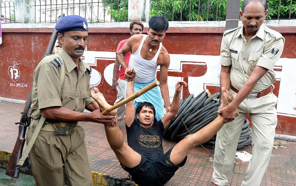 Police re-arresting a youth who ran away from the lock-up in Patna.