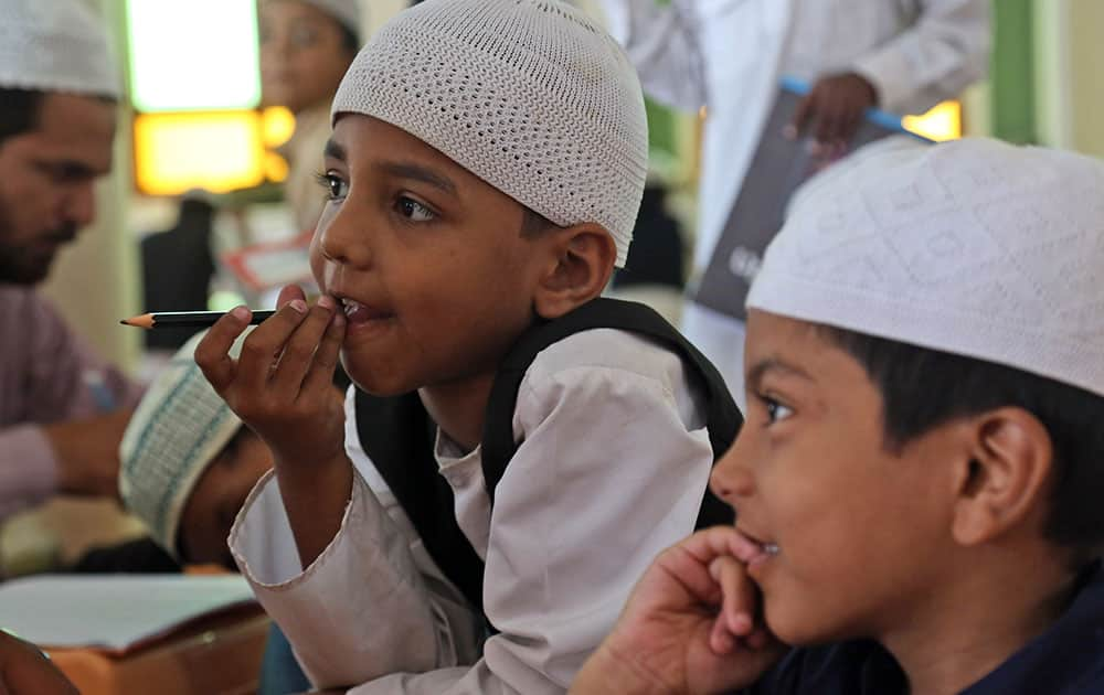 A Muslim children attend a class at a madrasa, or religious school, during the holy month of Ramadan in Hyderabad.