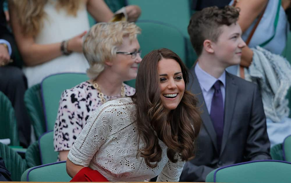 Kate, Duchess of Cambridge takes her seat in the Royal Box on centre court ahead of the women`s singles quarterfinal match between Simona Halep of Romania and Sabine Lisicki of Germany at the All England Lawn Tennis Championships in Wimbledon.