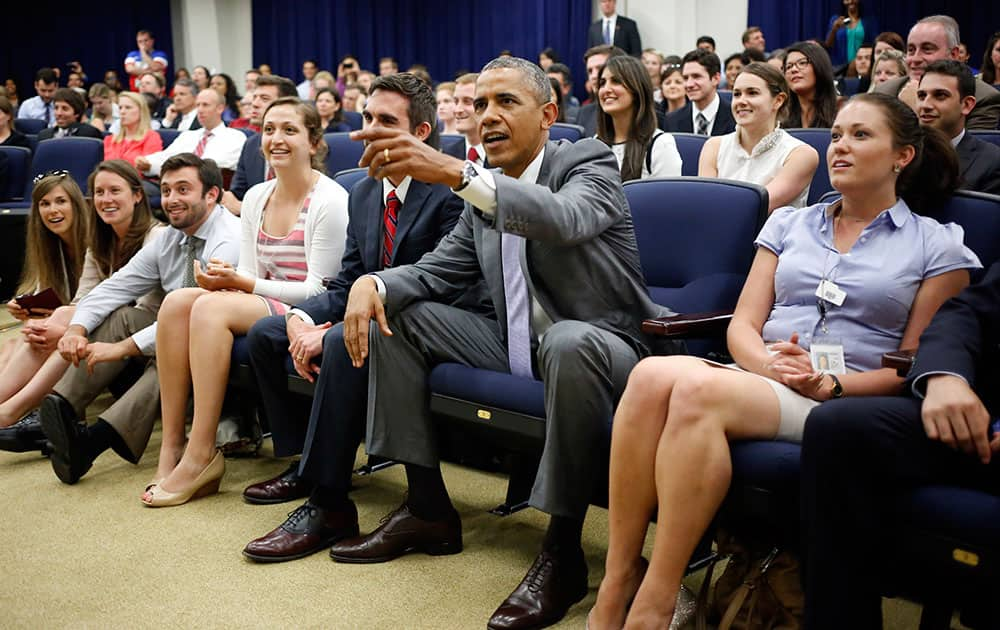 President Barack Obama watches the U.S. vs. Belgium World Cup soccer game at the Eisenhower Executive Office Building with White House staff members on the White House grounds in Washington.