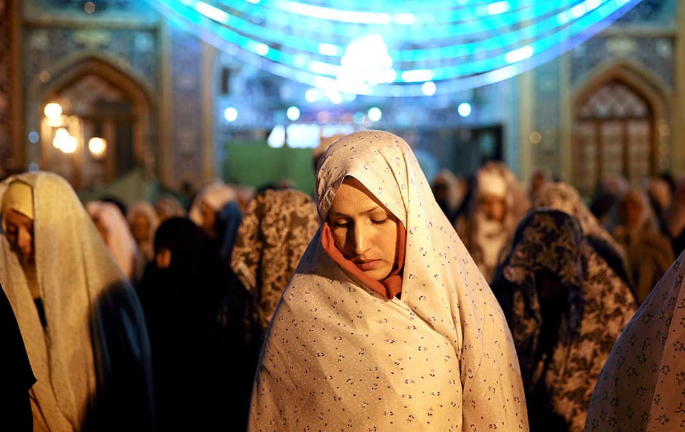 Iranian women perform their evening prayers, at the shrine of Shiite Saint Saleh during the Muslim holy fasting month of Ramadan in northern Tehran.