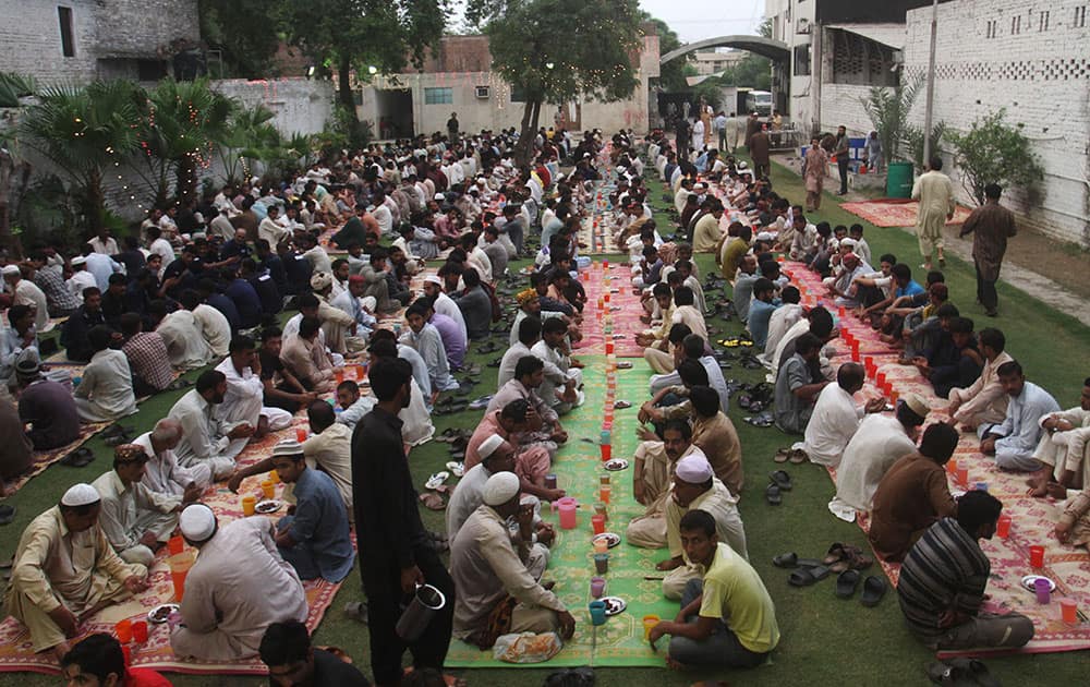 Pakistani Muslims wait to break their fast at sunset, during the Muslim holy month of Ramadan in Lahore, Pakistan.