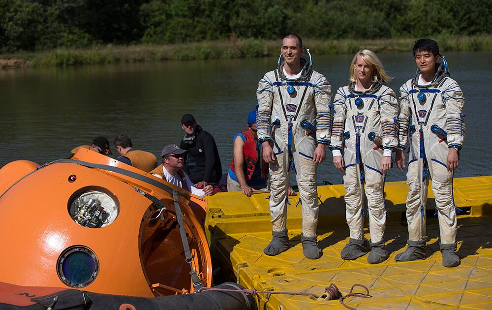 Russian cosmonaut Anatoly Ivanishin, left, NASA`s U.S. flight engineer Kathleen Rubins, center, and Japanese space agency`s flight engineer Takuya Onishi, right, pose for a photo prior to undergoing training near in Noginsk, 60 km (38 miles) east of Moscow, Russia.