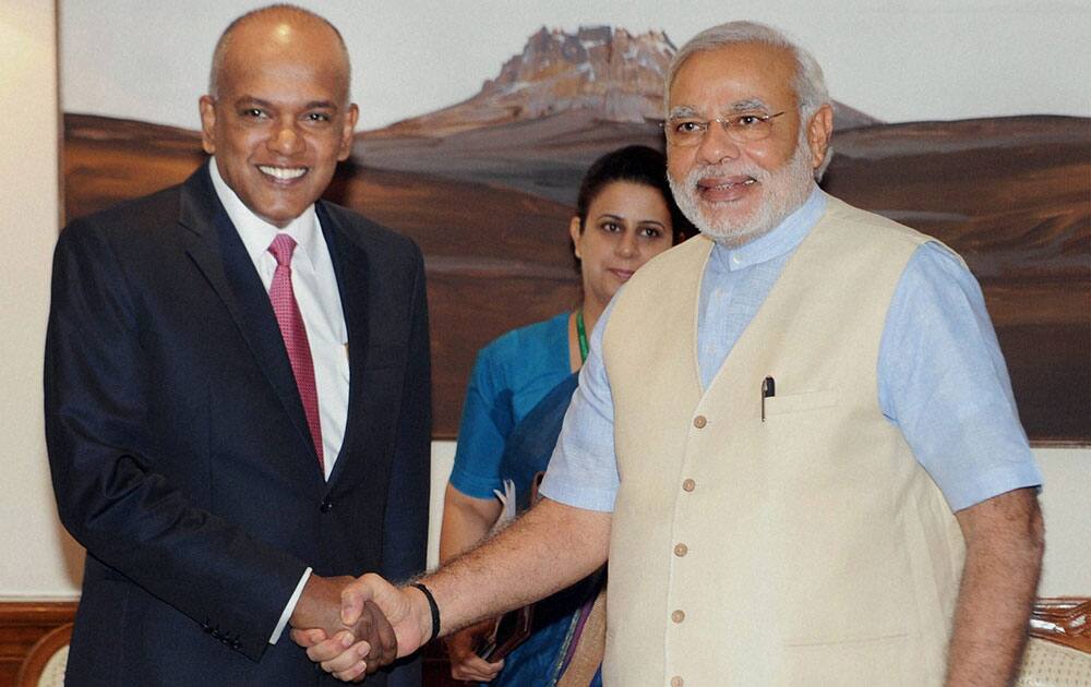 Prime Minister Narendra Modi shakes hand with Minister for Foreign Affairs & Minister for Law of Singapore, K. Shanmugam during their meeting in New Delhi.