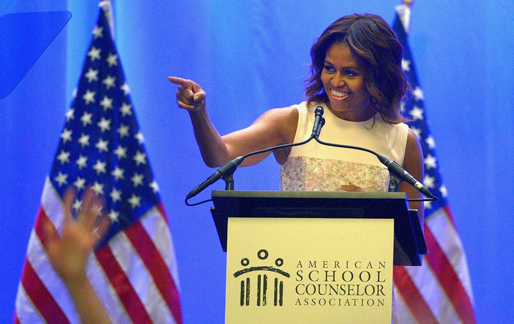 First lady Michelle Obama points towards the audience while speaking to members of the American School Counselor Association during their annual conference as part of her Reach Higher Initiative, in Lake Buena Vista, Fla. 