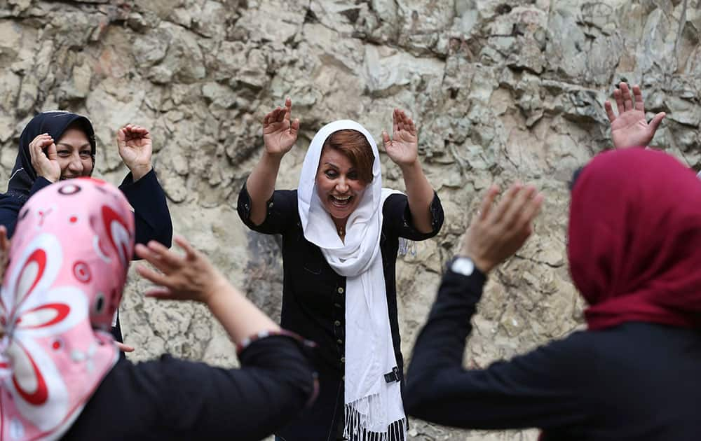 A group of Iranian women take part in an outdoor session of Laughter Yoga in the Darakeh mountainous area north of Tehran, Iran.