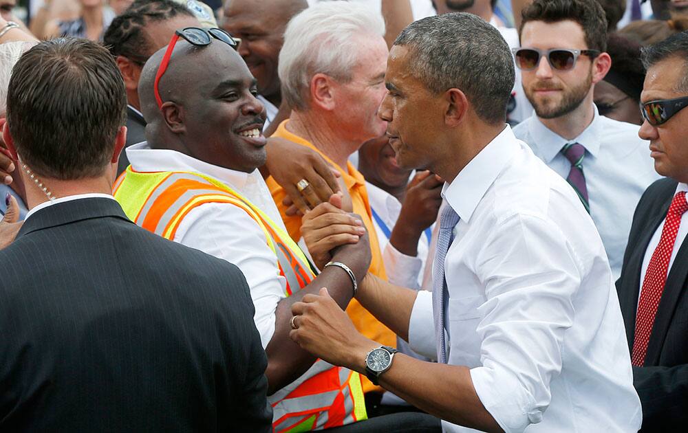 President Barack Obama greets audience members after he spoke about transportation and the economy, at the Georgetown Waterfront Park in Washington. 