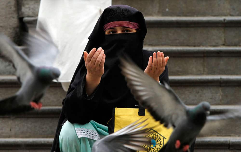 A Kashmiri woman prays outside the shrine of Shah-e-Hamdan during the holy month of Ramadan in Srinagar.