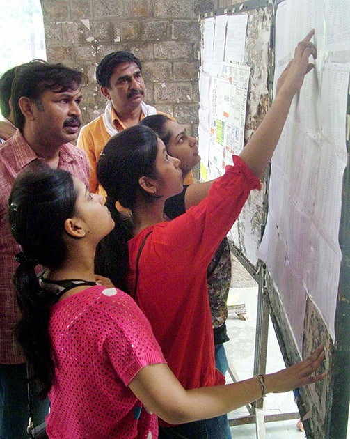 Admission seekers check their names in the first cut off list of Delhi University at North campus in New Delhi.