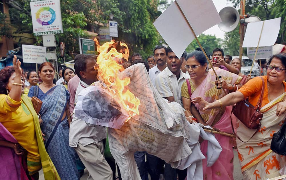 Activists of BJP Mahila Morcha burning an effigy of TMC MP Tapas Paul during a protest over his controversial comments on women, in Kolkata.