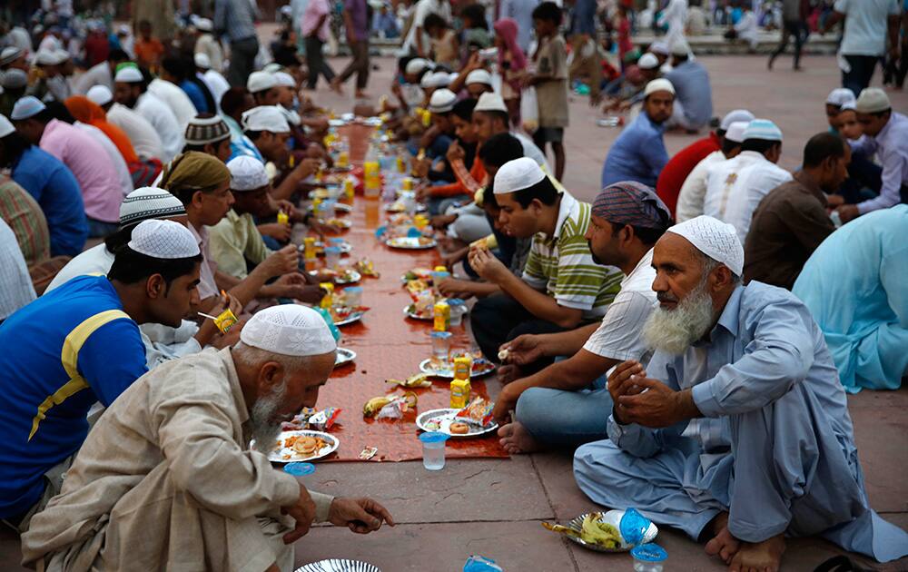 Muslims break fast on the first day of the holy month of Ramadan at the Jama Mosque in New Delhi.