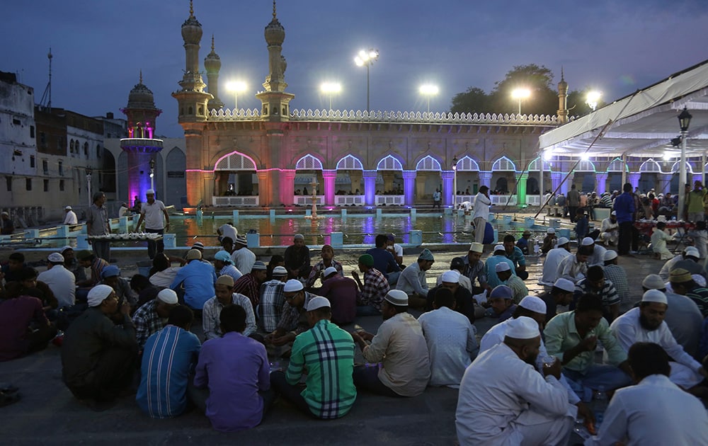 Indian Muslims break their fast on the first day of holy month Ramadan at the Mecca Mosque in Hyderabad.