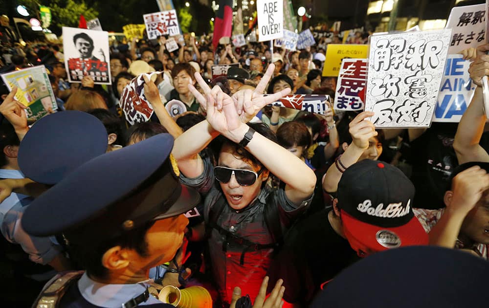 Protesters are blocked by police officers during a rally outside Prime Minister Shinzo Abe’s official residence in Tokyo.