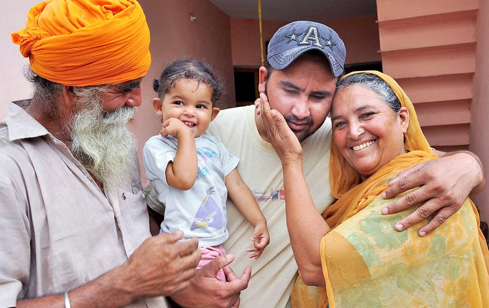 Harjinder Singh who returned from Iraq, with his family members in Khatoli village in Patiala.