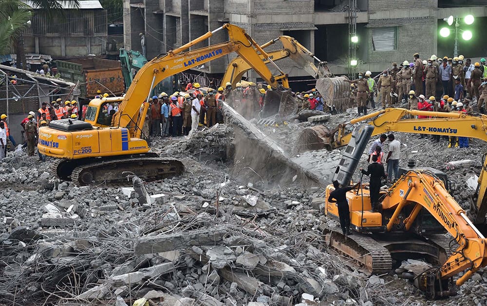 Rescue workers at the collapsed eleven-storey building near suburban Porur in Chennai.