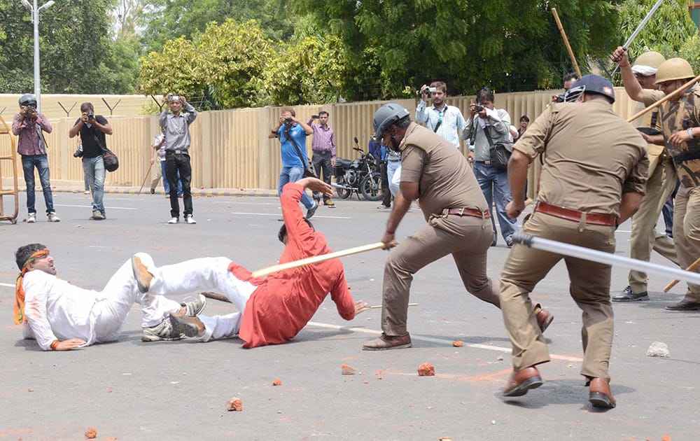 Police charge BJP Yuva Morcha activists during a protest outside Vidhan Bhawan in Lucknow.