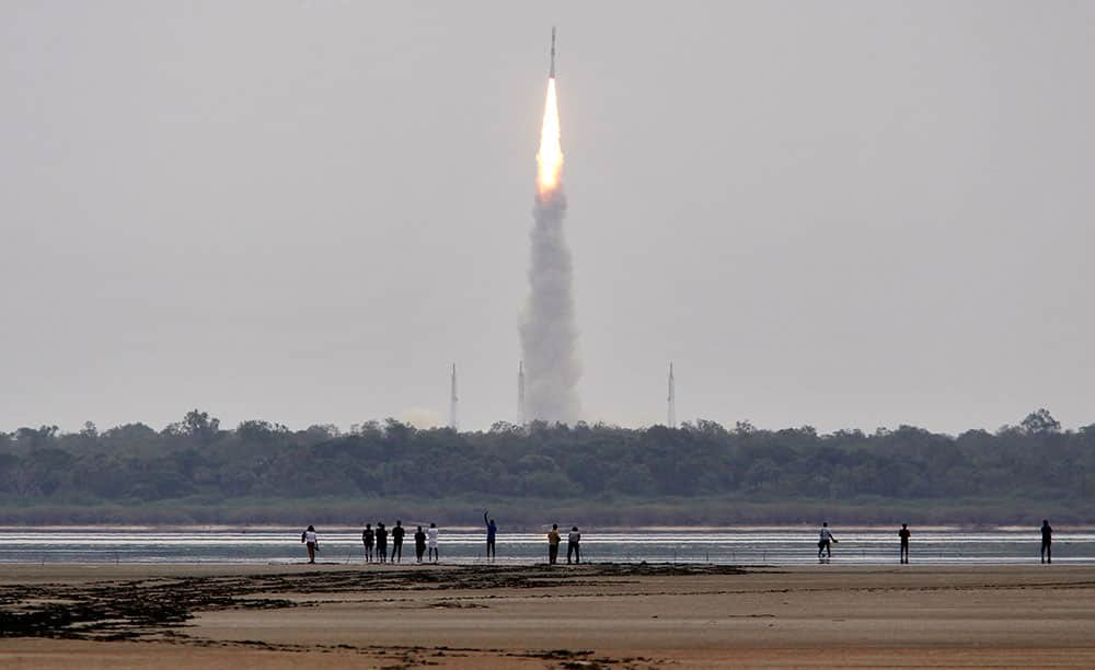 Indians watch the Polar Satellite Launch Vehicle (PSLV-C23) rocket lifting off from the east coast island of Sriharikota.