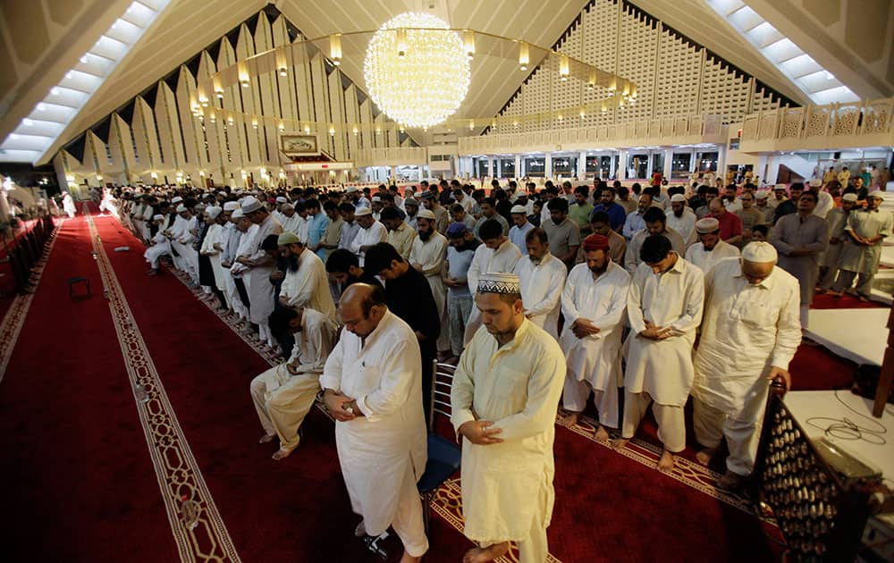 Pakistan Muslims offer an evening prayer called `tarawih` marking the first eve of the holy fasting month of Ramadan, at Grand Faisal Mosque in Islamabad, Pakistan.