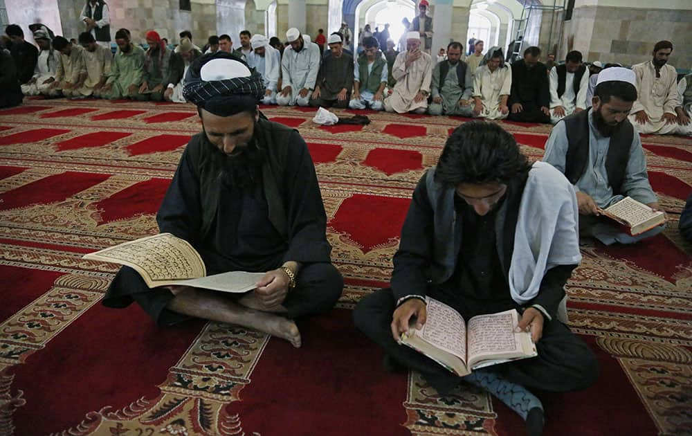 Afghan men reads the Quran during the Muslim holy month of Ramadan at a mosque in Kabul.