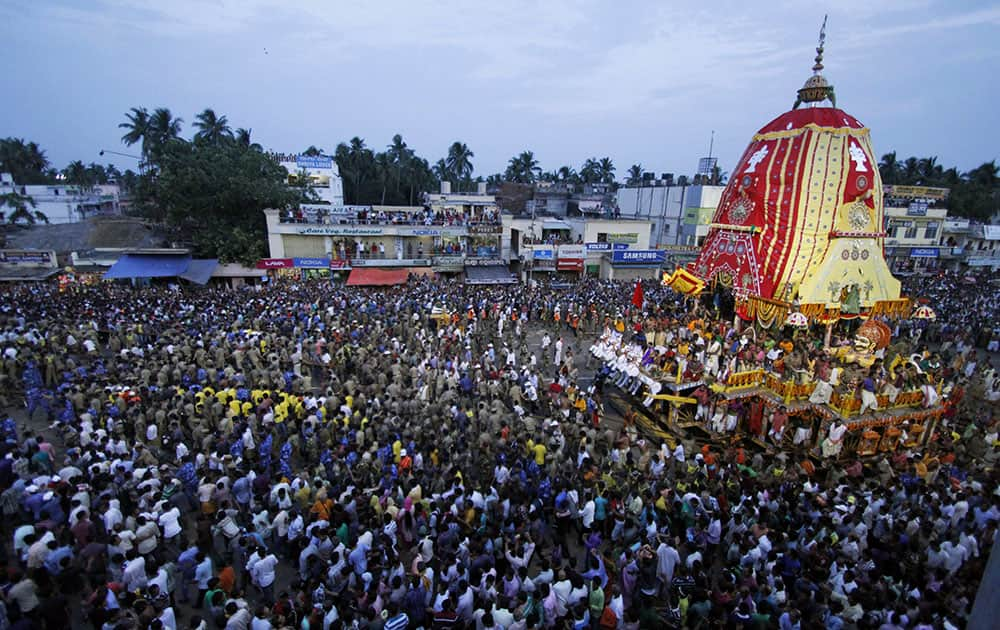 Devotees throng around a chariot as they pull it during the annual Hindu festival ‘Rath Yatra’ or chariot procession in Puri, Orissa state.