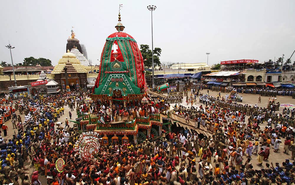 Devotees gather around the chariot of Lord Balabhadra during the annual Hindu festival ‘Rath Yatra’ or chariot procession in Puri, Orissa state.