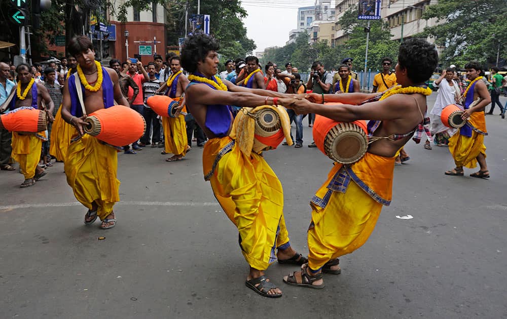 Hindu devotees with percussion instruments dance during the annual Hindu festival ‘Rath Yatra’ or chariot procession in Kolkata.