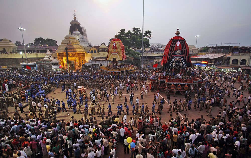 Devotees and paramilitary forces pull chariots to set in front of the Lord Jagannath temple, on the eve of the annual Rath Yatra, or Chariot procession, at Puri, 65 kilometers (40 miles) away from the eastern Indian city of Bhubaneswar.