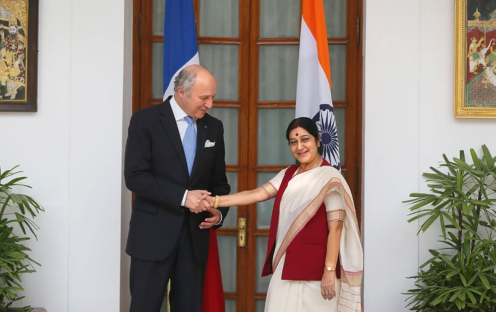 Foreign Minister Sushma Swaraj, right, shakes hand with her French counterpart Laurent Fabius in New Delhi.