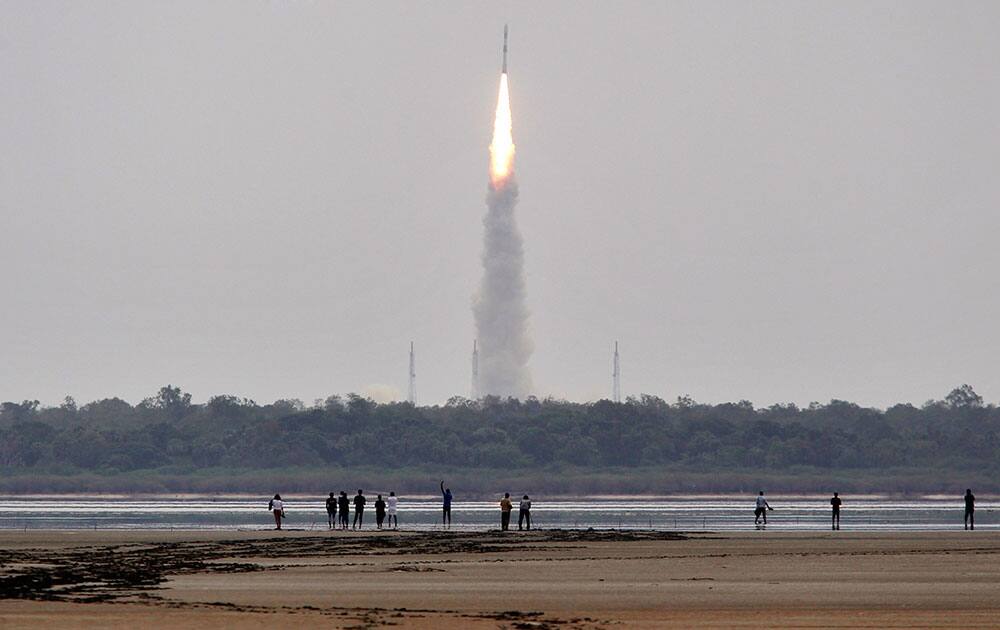 Indians watch the Polar Satellite Launch Vehicle (PSLV-C23) rocket lifting off from the east coast island of Sriharikota.