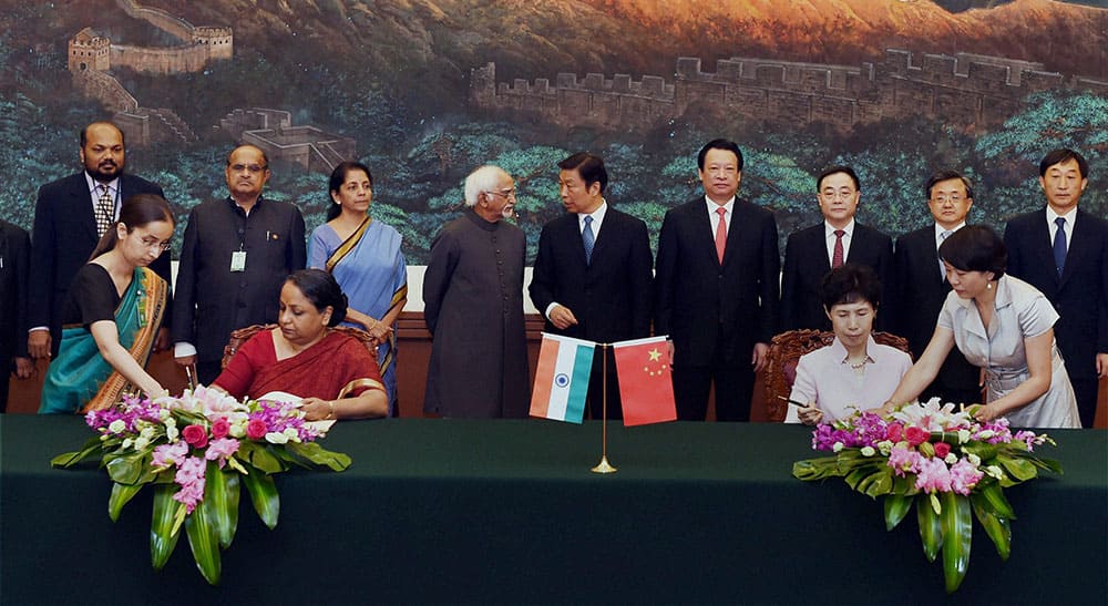 Foreign Secretary Sujatha Singh and Chinese Vice Minister of Commerce Gao Min sign an MoU in the presence of Vice President Hamid Ansari and his Chinese counterpart Li Yuanchao accompanied by Union Minister for Commerce and Industry Nirmala Sitharaman the Indian delegation of MP`s and others participate at the Great Hall in Beijing.