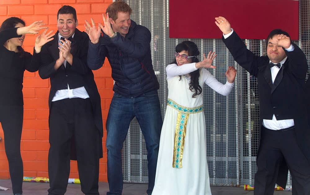 Britain`s Prince Harry, third from left, visits children at the Foundation Amigos de Jesus in Santiago, Chile. The foundation helps children with special needs.