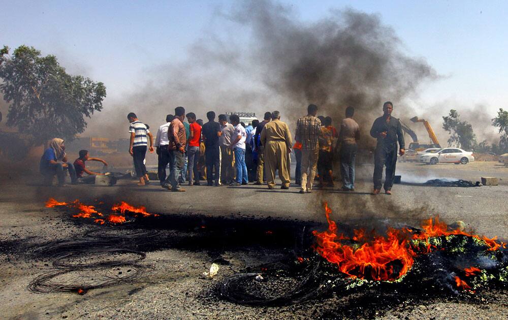 Iraqi Kurds block a road during a demonstration against the fuel crisis in Irbil, Iraq. In Irbil, a city controlled by ethnic Kurds, lines stretched for miles at gas stations for weeks causing demonstrations.